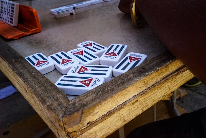 <p>Old men play dominos on the streets of Vedado</p>