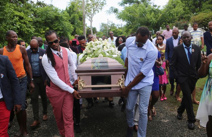 Usain Bolt, right, carries the coffin of former Team GB athlete Germaine Mason, who died in a motorcycle crash in Jamaica last month