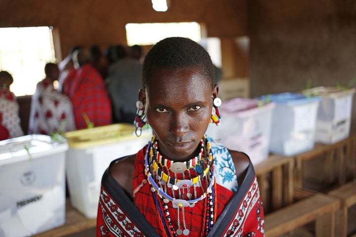 A woman leaves a polling station after casting her vote during the 2013 Kenyan elections.