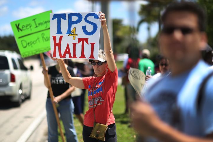 Protesters gather in front of the U.S. Citizenship and Immigration Services office in Broward County, Florida, on May 21 to urge the Department of Homeland Security to extend temporary protected status for Haitian immigrants.