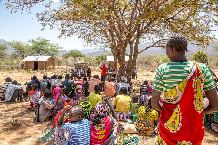 A community in rural West Pokot County, Kenya, gathers to learn about obstetric fistula at an outreach event.