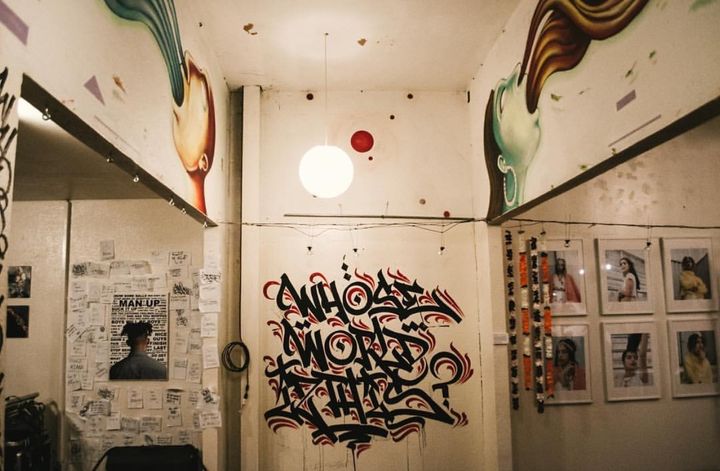 An overview of the exhibition space focusing on a graffiti piece created by Daniel Paniagua.