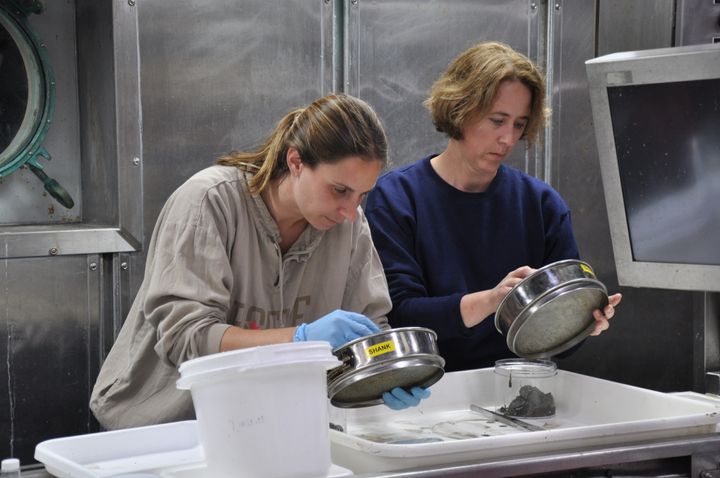 Heyl, left, identifies samples of marine life onboard Alvin, one of the Woods Hole Oceanographic Institute research ships.