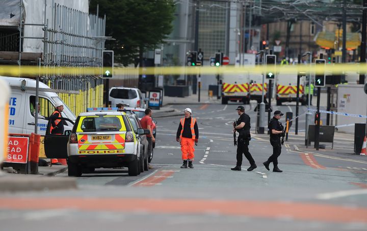 Police remain at the scene on Tuesday morning after a suspected terror attack on the Manchester Arena