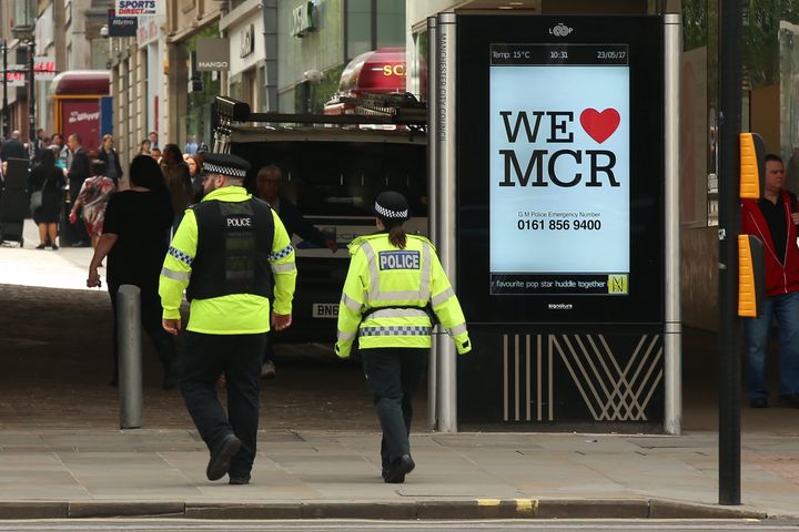 We Love Manchester signs have begun to pop up around the city to show solidarity and to share a helpline for those affected