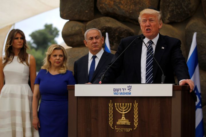 U.S. President Donald Trump, flanked by Israel's Prime Minister Benjamin Netanyahu (3rd L) and their wives Melania Trump (L) and Sara Netanyahu (2nd L), delivers remarks after a wreath-laying at the Yad Vashem holocaust memorial in Jerusalem May 23, 2017.