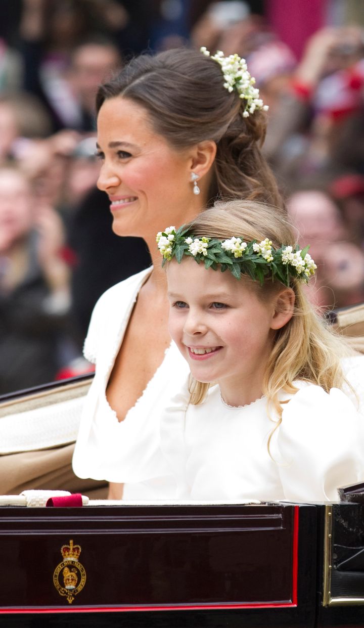 Pippa Middleton, sister of Kate, Duchess of Cambridge, travels with bridesmaid Margarita Armstrong-Jones in a carriage along the Processional Route to Buckingham Palace after the wedding ceremony, in London, on April 29, 2011.