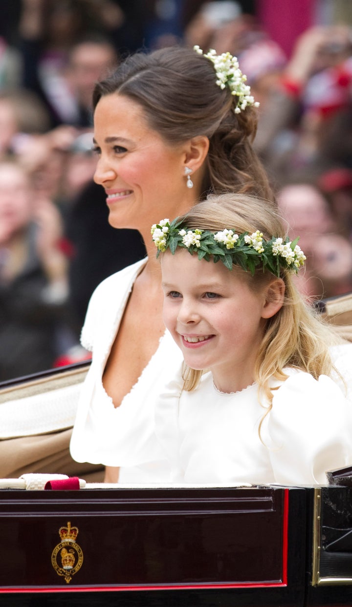 Pippa Middleton, sister of Kate, Duchess of Cambridge, travels with bridesmaid Margarita Armstrong-Jones in a carriage along the Processional Route to Buckingham Palace after the wedding ceremony, in London, on April 29, 2011.