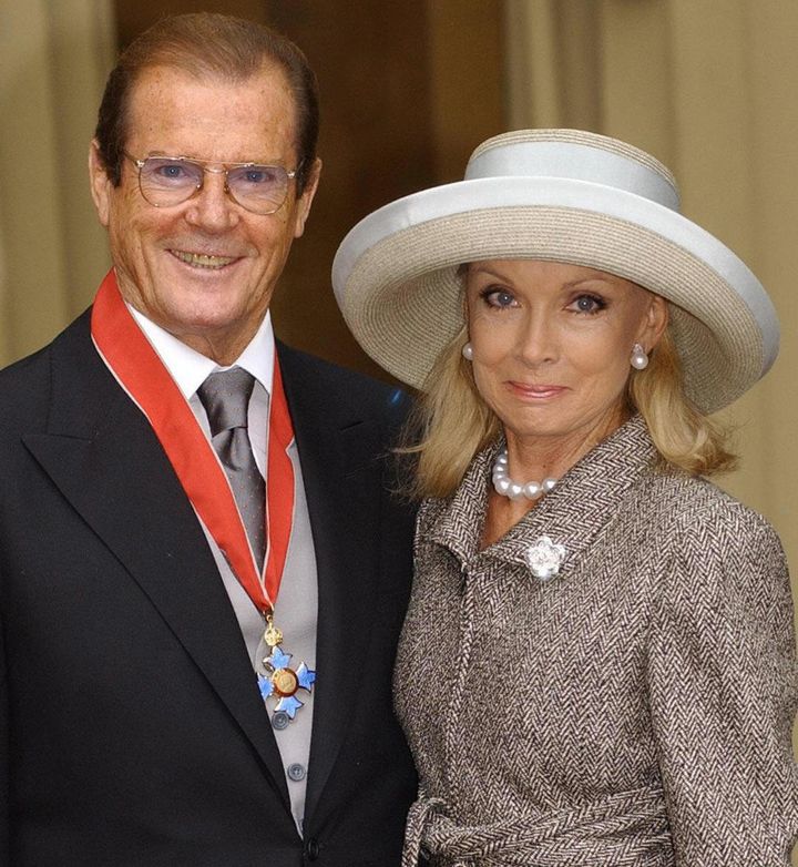 Roger Moore and wife Kristina Tholstrup after Moore received his Knighthood at Buckingham Palace in London, 2003.
