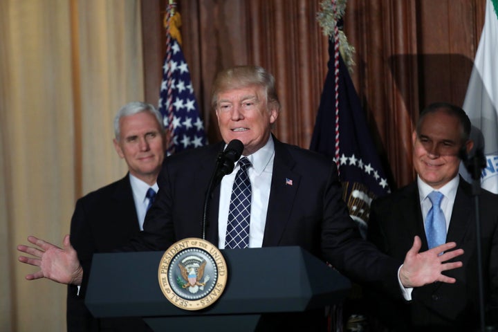 President Donald Trump, flanked by Vice President Mike Pence, left, and Environmental Protection Agency Administrator Scott Pruitt, plans to cut funding to the EPA to $5.65 billion.