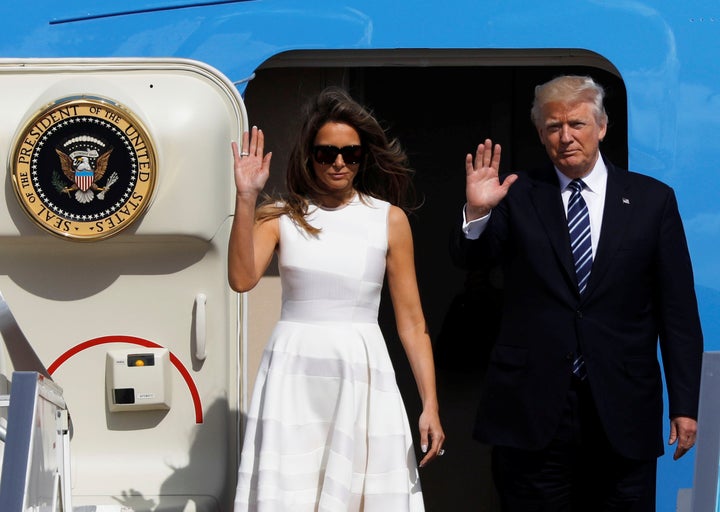 President Donald Trump and first lady Melania Trump wave as they board Air Force One to travel to Rome from Ben Gurion International Airport near Tel Aviv, Israel, May 23, 2017.