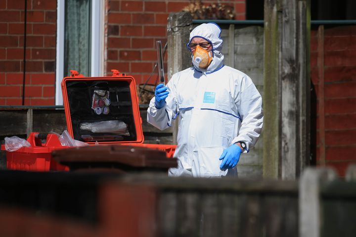 A police forensic investigator at an address in Elsmore Road, Greater Manchester, after a suicide bomber killed 22 people, including children, as an explosion tore through fans leaving a pop concert in Manchester.