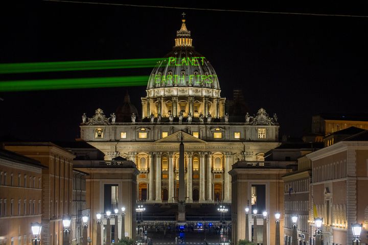A few hours before the meeting between Pope Francis and President Donald Trump, Greenpeace activists send a message on the dome of St. Peter's Basilica early Wednesday.
