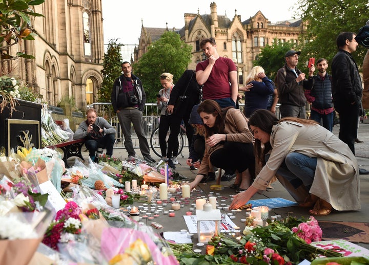 People leave tributes to the victims of the bombing in Manchester's Albert Square 