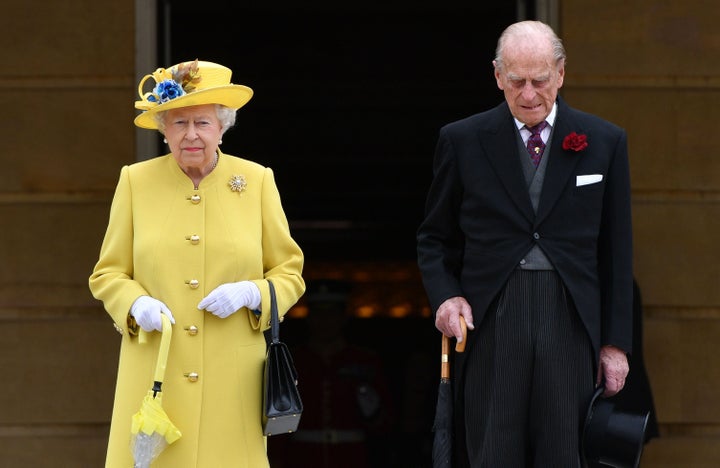 The Queen and Prince Philip both observed a minute's silence at the start of a garden party at Buckingham Palace on Tuesday 