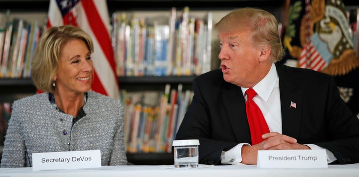 Secretary of Education Betsy DeVos and President Donald Trump participate in a round-table discussion during a visit to Saint