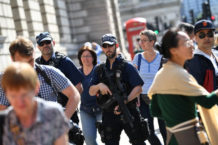Armed police patrol a street near the Palace of Westminster housing the Houses of Parliament on Wednesday