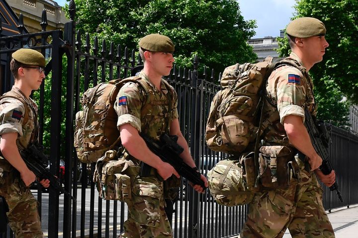 British soldiers enter a Ministry of Defence building near to New Scotland Yard police headquarters near to the Houses of Parliament