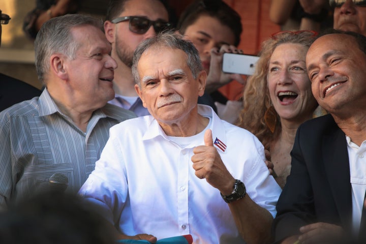 U.S. Rep. Luis Gutierrez (D-Ill.), right, and Puerto Rican nationalist Oscar López Rivera, center, attend a rally on May 18 in Chicago.