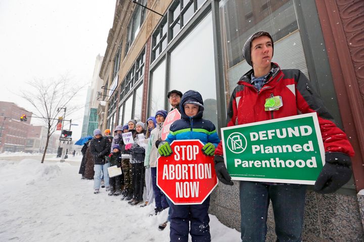 Anti-abortion protestors stand outside a Planned Parenthood clinic in Portland, Maine in February. 