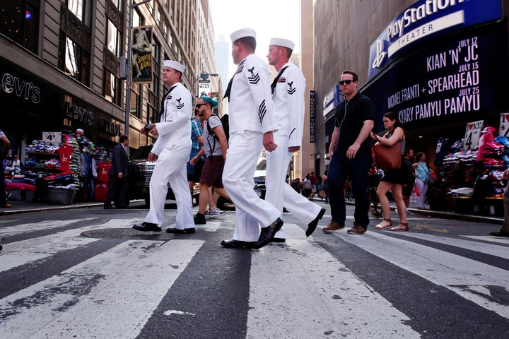 U.S. Navy sailors walk through Times Square during Fleet Week in New York City.