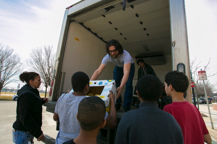 Lovin’ Spoonfuls driver Vinny Vassallo distributes food to a beneficiary in South Boston