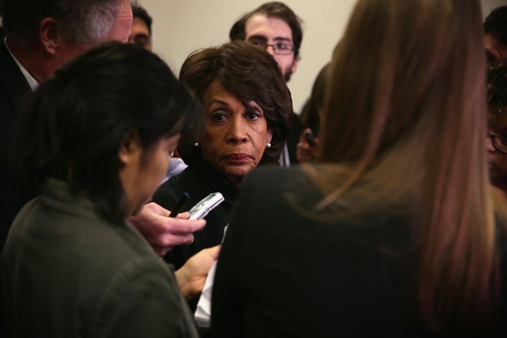 Rep. Maxine Waters (D-Calif.) manages to keep it together even though Guardian journalist Ben Jacobs is standing behind her. 