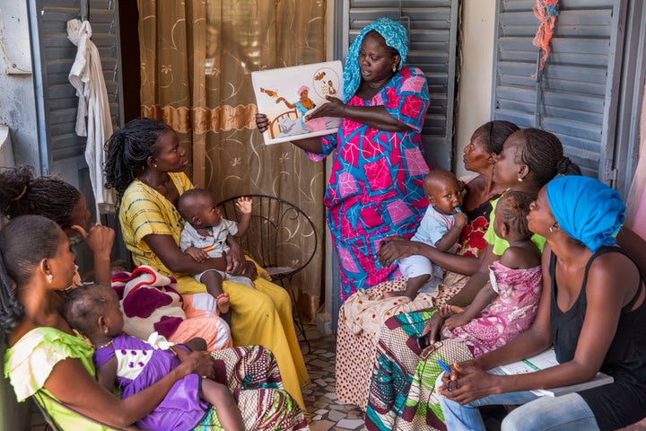 KAOLACK, SENEGAL - AUGUST 20: A community health worker providing women in her community counseling and post natal care at her home. 