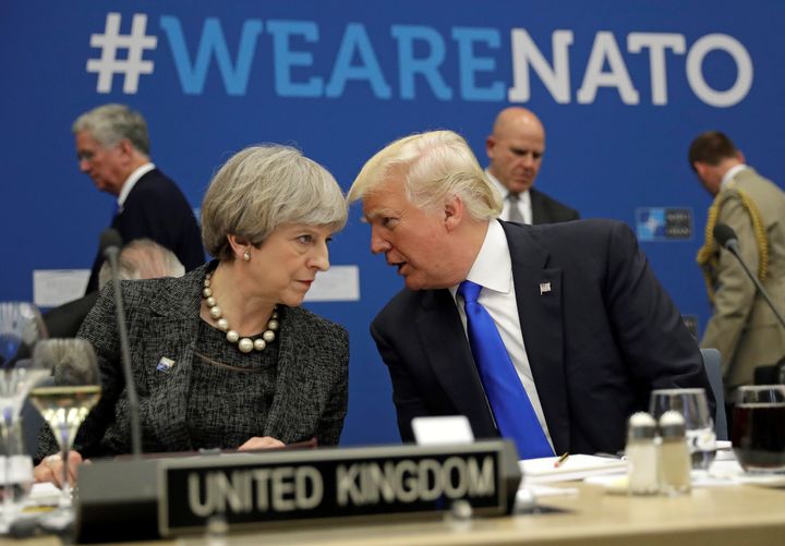 Trump was pictured speaking with Theresa May during a working dinner at Nato HQ in Brussels