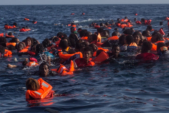 Refugees and migrants are seen swimming and yelling for assistance from crew members from the Migrant Offshore Aid Station vessel on May 24, 2017 near the Italian island of Lampedusa.