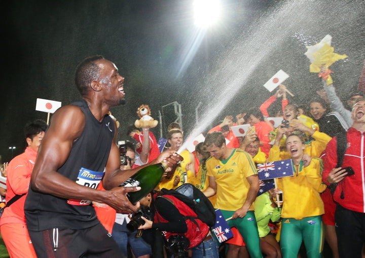 Usain Bolt of Usain Bolt's All-Star team sprays champagne on the teams after his team won the event during the Melbourne Nitro Athletics Series on February 11, in Melbourne, Australia.