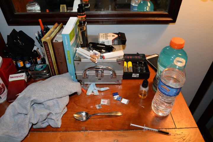 Drug packets and paraphernalia are shown atop the desk of one of the Freedom Ridge Recovery Lodge counselors who died Sunday.