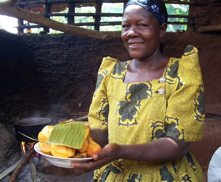  A Ugandan farmer with freshly steamed orange sweet potato, ready to eat 