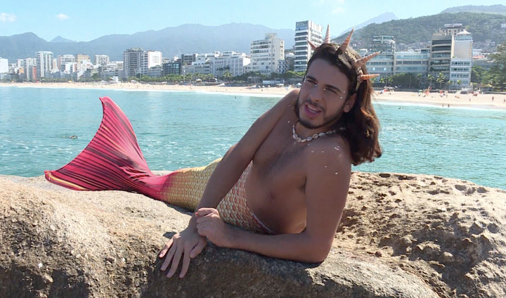 Moreira rests on a rock by the seaside. 