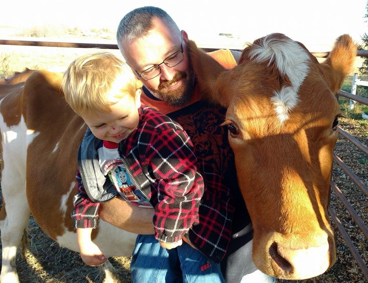 William Powers, here with his son, raises Guernseys on his dairy and chicken farm in Ceresco, Nebraska, a town of 900.