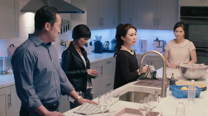 A family of Jehovah’s Witnesses is depicted reacting to a guest in their home who has two mothers