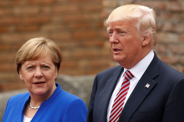 Donald Trump and Angela Merkel pose during a 'family photo' during the G7 summit in Taormina, Sicily