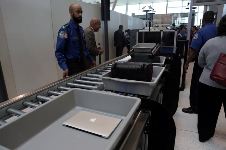 Baggage and a laptop are scanned using the Transport Security Administration's new Automated Screening Lane technology at Ter