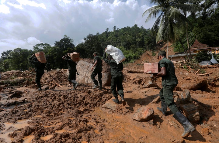 Rescue workers on Sunday made use of a brief respite in the rains to clear debris and improve access to some of the affected areas.This photo shows army soldiers carrying food and water for landslide affected people.