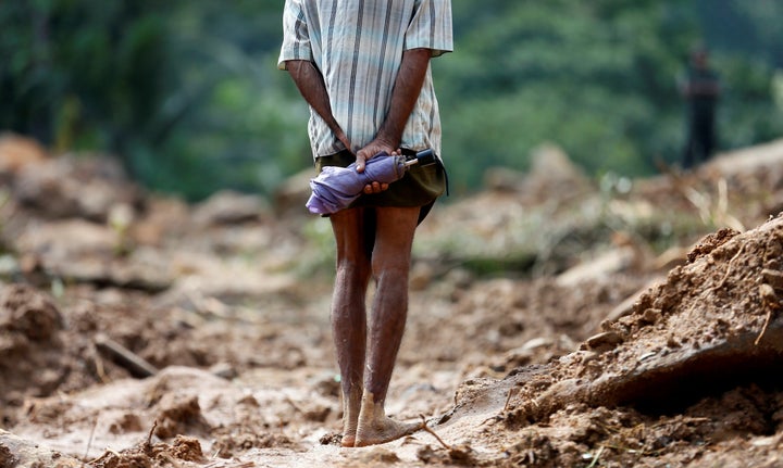 Torrential rains wreaked havoc in Sri Lanka in previous days. In this photo, a man looks at the site of a landslide in Athwelthota village. 