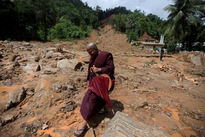 A Buddhist monk walks through a landslide site in Kalutara. 