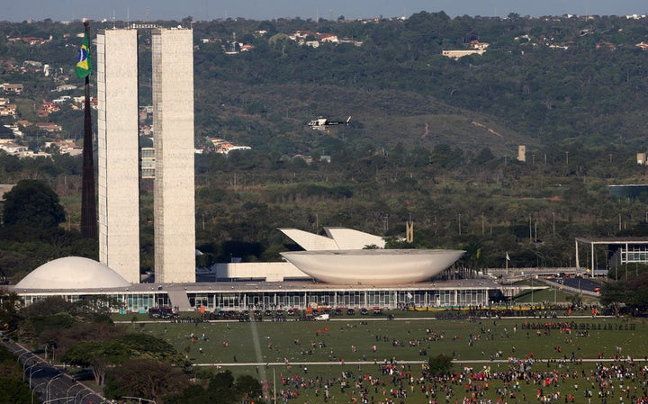 Police line up to defend Congress from protesters in the nation’s capital Brasilia, while the Temer government struggles. 