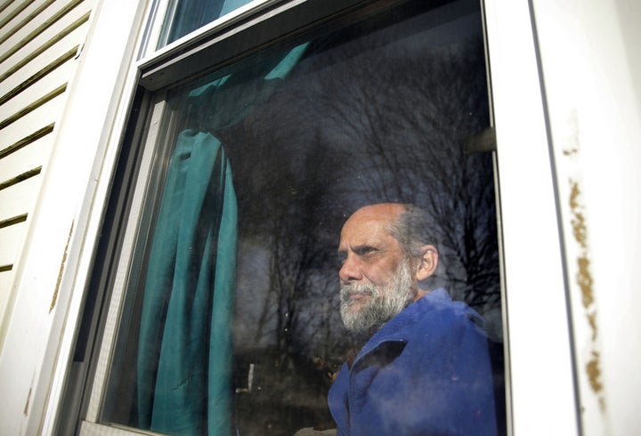  This U.S. Navy veteran poses for a picture in the home of a relative his family has been living with since being evicted from their own home.