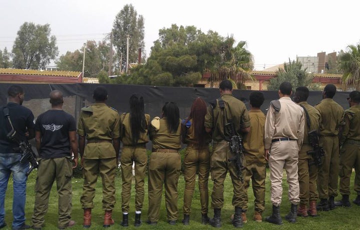 Soldiers from the African Hebrew Israelite community turn their backs to protest the Israeli army’s handling of Toveet’s case