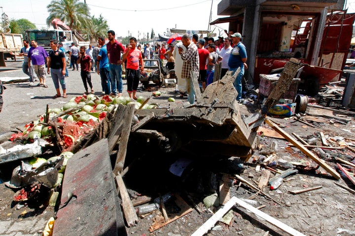 Iraqis gather at the site of a car bomb explosion near Baghdad's Al-Shuhada Bridge.