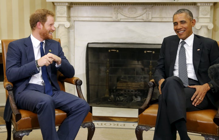 Former U.S. President Barack Obama talks to Britain's Prince Harry during a meeting at the Oval Office at the White House on October 28, 2015