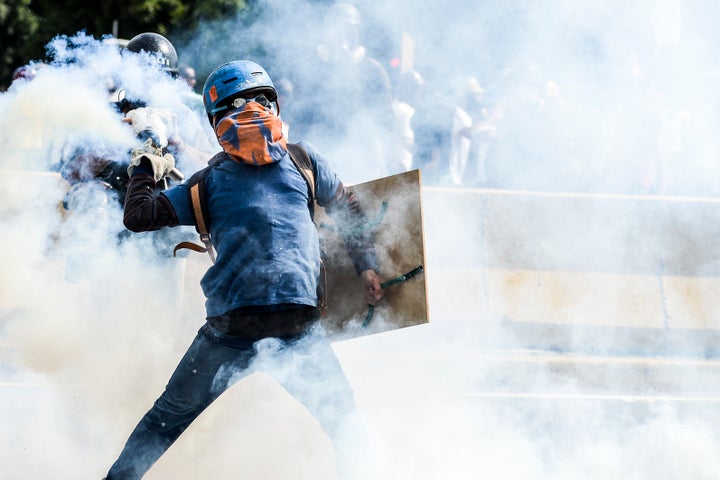 Opposition activists and riot police clash during a demonstration against Maduro. Caracas, May 29.