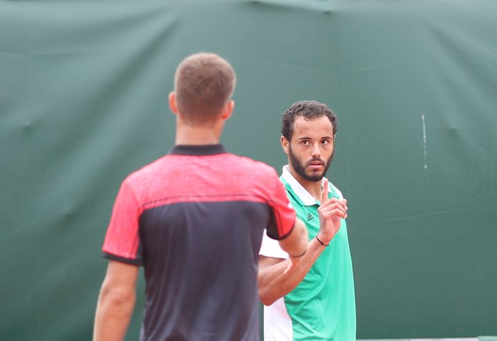 Laurent Lokoli's refusal to shake hands with winner Martin Klizan came after Klizan teased him for a double fault.
