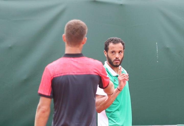 Laurent Lokoli's refusal to shake hands with winner Martin Klizan came after Klizan teased him for a double fault.