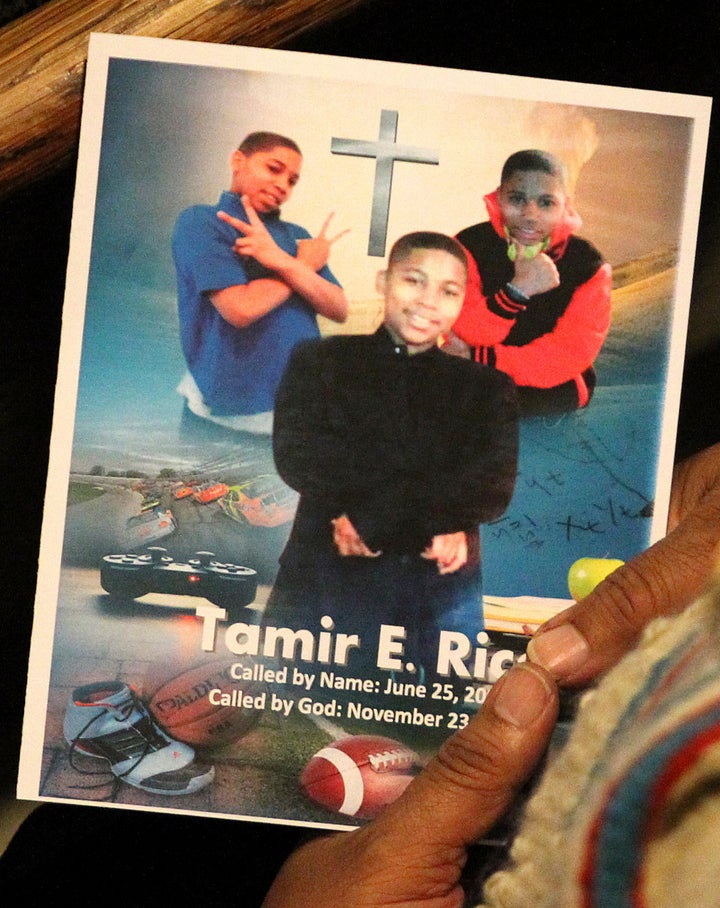 A mourner looks at a program during the funeral service for Tamir Rice in Cleveland on Dec. 3, 2014.